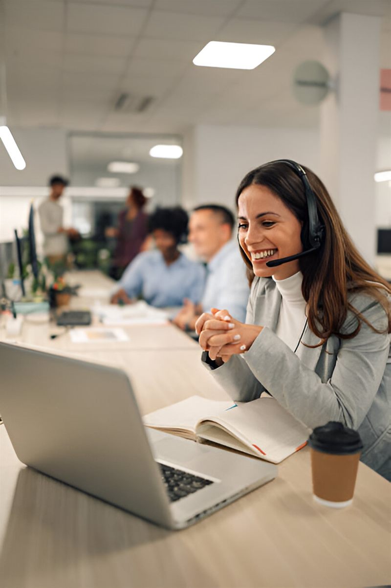 Colleagues working at laptops in a bright open-plan office